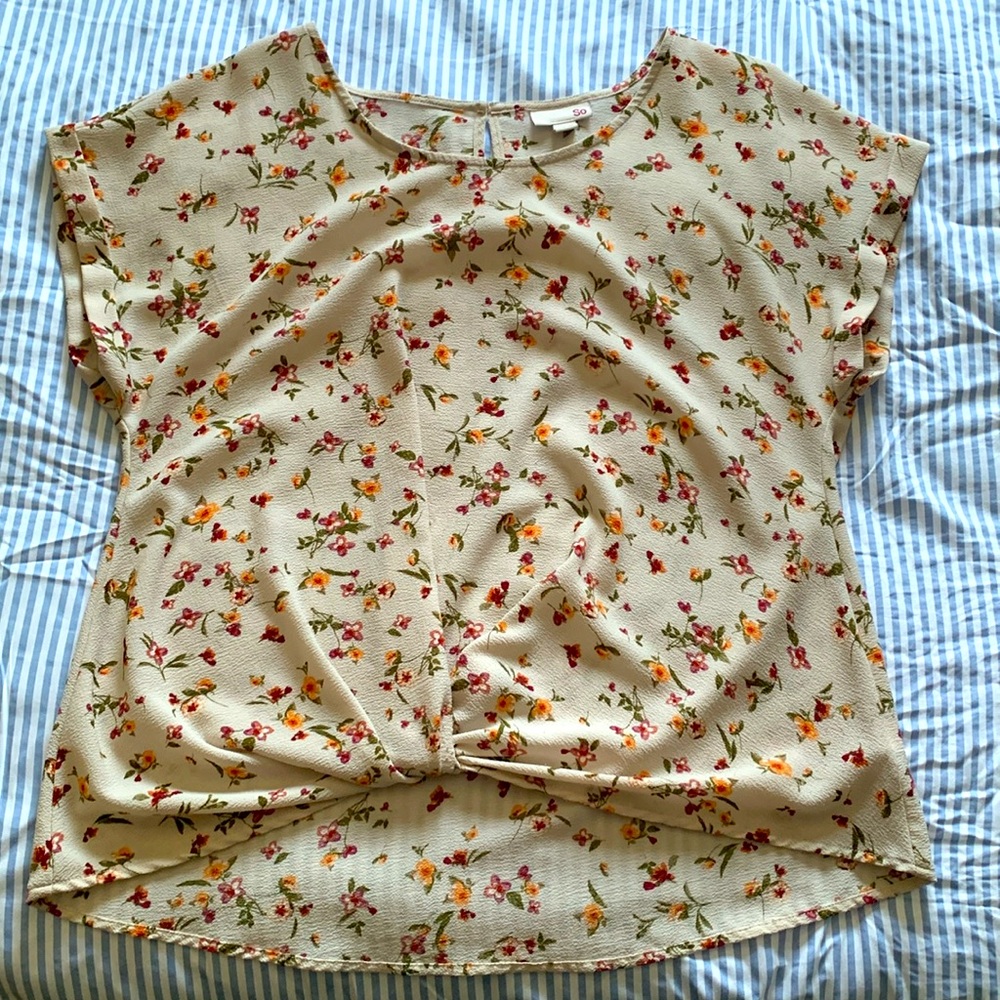 Tan floral blouse.